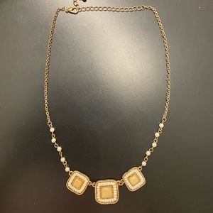 Gold colored woman’s necklace
